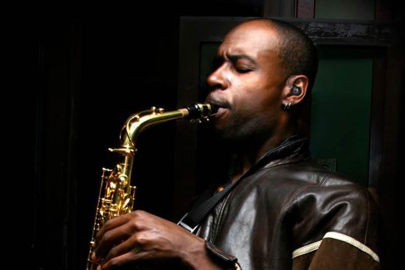man playing the saxaphone with ear protectors man playing the saxaphone with ear protectors