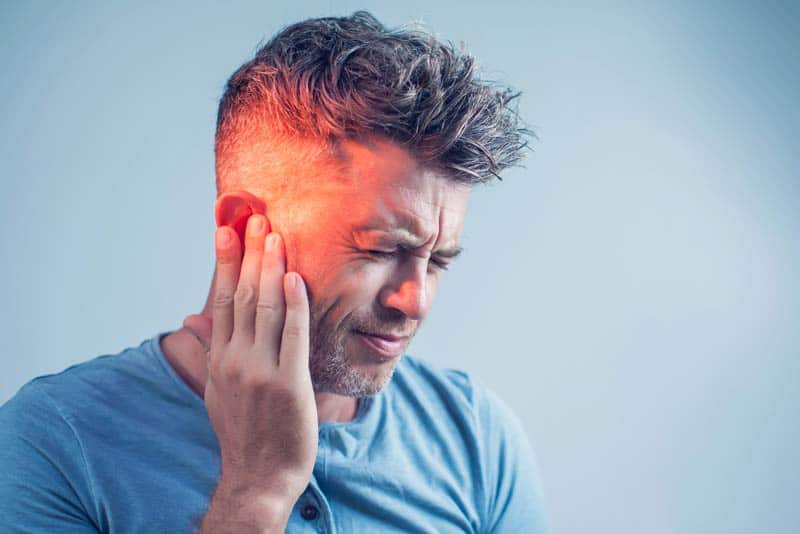 man suffering from tinnitus man suffering from tinnitus